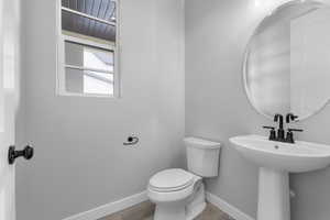 Bathroom featuring sink, wood-type flooring, and toilet