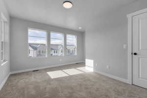 Unfurnished room with light colored carpet