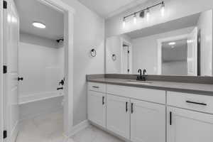 Full bathroom with vanity,  shower combination, and toilet