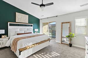 Bedroom featuring access to outside, ceiling fan, carpet flooring, and lofted ceiling