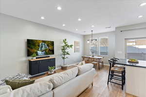 Living room with a chandelier and hardwood / wood-style floors