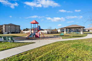 View of play area with a lawn and a gazebo