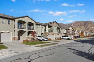 Multi unit property featuring a mountain view and a garage