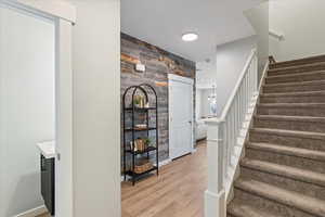 Stairway featuring wood walls and wood-type flooring