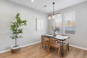 Dining room with light hardwood / wood-style flooring