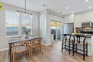 Dining room with light hardwood / wood-style floors