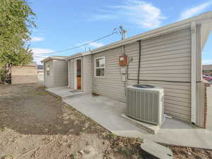 Rear view of house featuring central AC