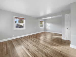 Empty room featuring plenty of natural light and light wood-type flooring