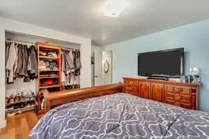 Bedroom with light hardwood / wood-style flooring