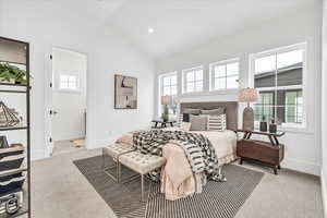 Carpeted bedroom with lofted ceiling