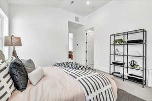 Bedroom with carpet and vaulted ceiling