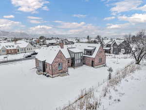 Snowy aerial view featuring a mountain view