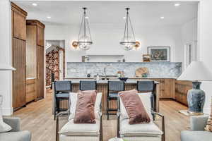 Living room with an inviting chandelier and light hardwood / wood-style flooring