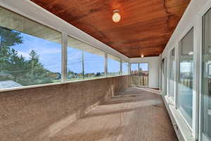 Unfurnished sunroom with wood ceiling