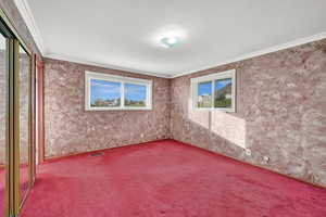 Unfurnished room featuring carpet floors and ornamental molding