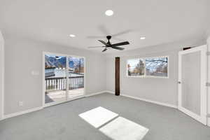 Carpeted empty room featuring ceiling fan