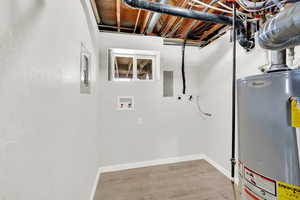 Interior space featuring electric panel and gas water heater