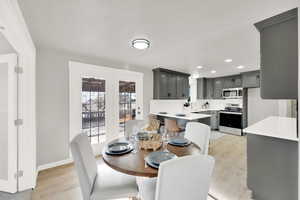 Dining area with light wood-type flooring and sink