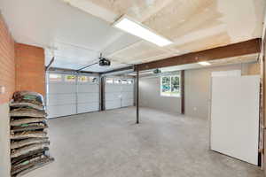 Garage with white refrigerator and a garage door opener