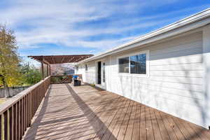 Wooden deck featuring a pergola