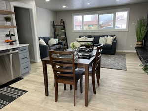 Dining area with a textured ceiling and light hardwood / wood-style floors