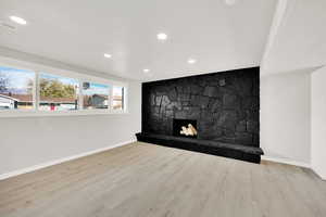 Room details featuring a fireplace and wood-type flooring