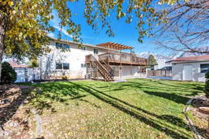 Rear view of property with a lawn, central air condition unit, a pergola, a storage unit, and a deck