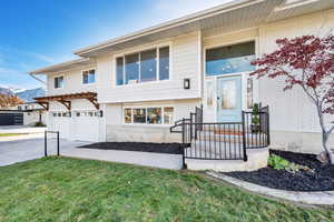 View of front of home with a garage and a front lawn