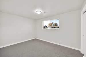 Unfurnished room with carpet flooring and a textured ceiling