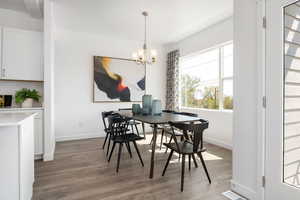 Dining area featuring hardwood / wood-style flooring and a notable chandelier