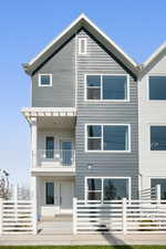 Back of house featuring a balcony