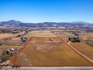 Birds eye view of property with a mountain view and a rural view