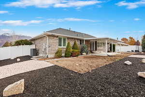 Back of house featuring a mountain view, cooling unit, and a patio area