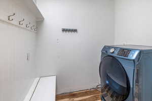 Laundry area with washer / clothes dryer and hardwood / wood-style flooring