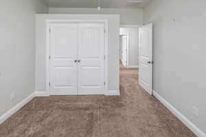 Unfurnished bedroom with carpet floors and a closet