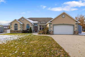 Ranch-style home featuring a garage and a front yard