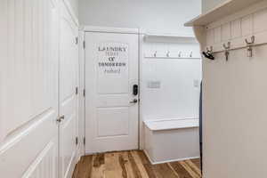 Mudroom with light hardwood / wood-style floors