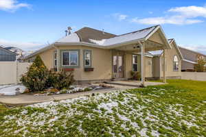 Rear view of property with a lawn