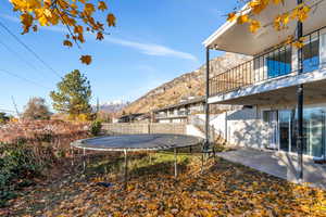 View of yard featuring a mountain view and a trampoline