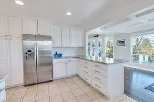 Stainless steel appliances, white cabinetry, lots of light