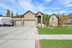 View of front of house featuring a garage and a front lawn