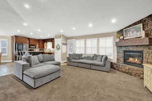 Carpeted living room with a fireplace and sink