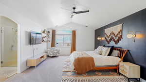 Carpeted bedroom with vaulted ceiling and ceiling fan