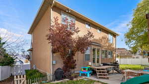 Back of house with a deck and a patio area