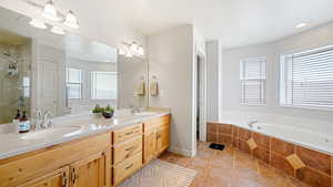 Bathroom featuring separate shower and tub, tile patterned flooring, vanity, and a healthy amount of sunlight