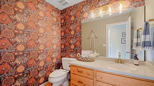 Bathroom featuring vanity and toilet