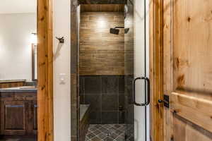 Bathroom featuring vanity and a shower with shower door