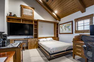 Bedroom featuring carpet flooring, vaulted ceiling with beams, and wooden ceiling