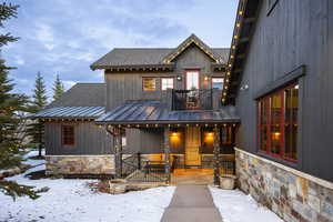 View of front of house featuring a balcony and a porch