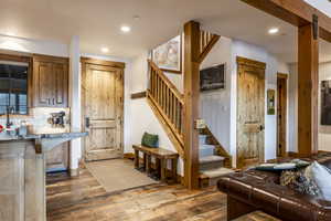 Interior space with decorative backsplash, dark hardwood / wood-style flooring, and a breakfast bar